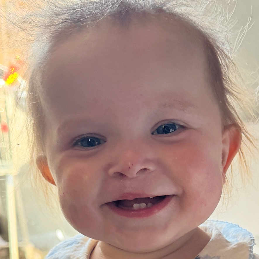 Elsie joined the competition — help win amazing prizes! baby, blue_eyes, child, clothing, collar, cute, dress, face, floral_pattern, hair, happy, indoors, infant, natural_light, person, portrait, skin, smiling, window_light, young_child