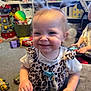 toddler, child, smiling, indoor, toys, pigtails, leopard_print, carpet, person, playroom, furniture, colorful, happy, baby, clothing, young_child, face, hair, cute, messy
