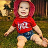 baby, barefoot, casual, child, cute, daylight, grass, greenery, happy, hat, nature, outdoor, portrait, red_clothing, shorts, sitting, smiling, summer, usa, yard