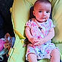 baby, baby_chair, butterfly_pattern, child, clothing, comfortable, cute, expression, face, green_chair, hands, indoor, infant, legs, person, sitting, soft_toy, toy, white_socks, young_child