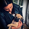 Burger joined the competition — help win amazing prizes! affection, brown_dog, caring, casual_clothing, cute, dog, floor, hands, holding, home, indoor, leather_jacket, long_hair, looking_down, love, pet, portrait, puppy, window, woman