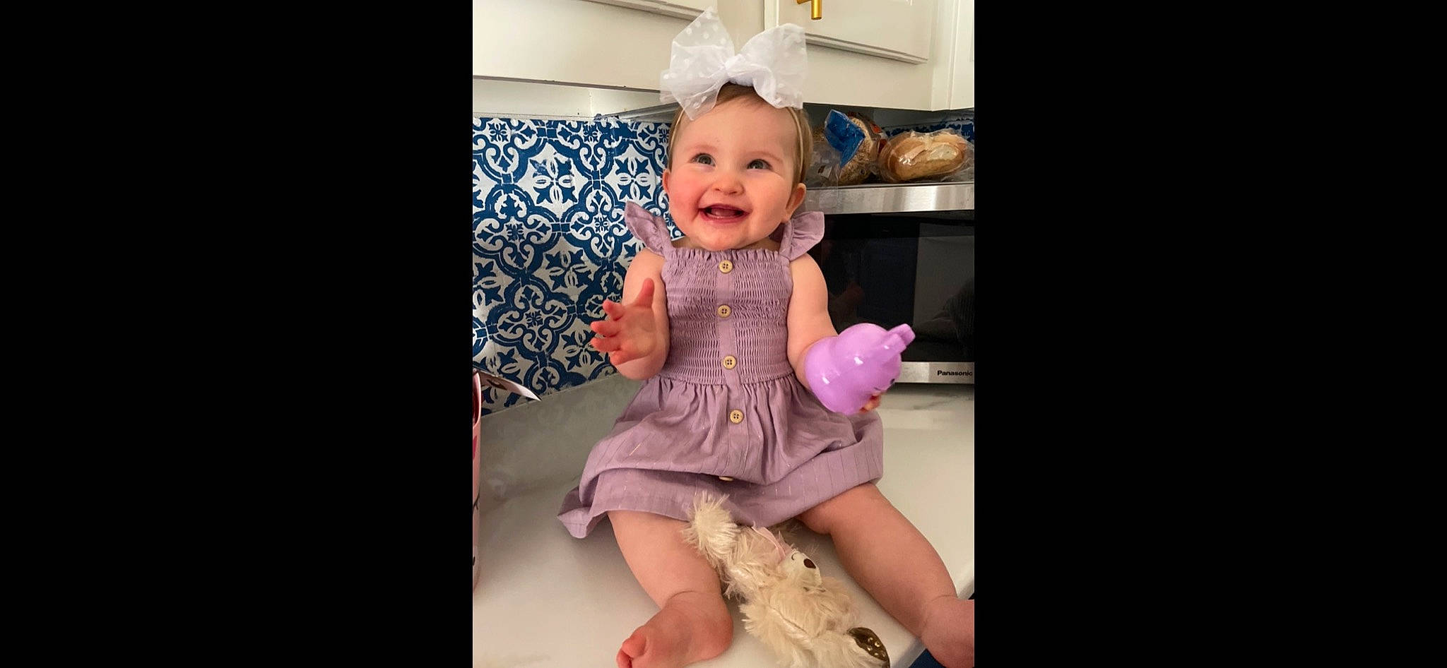 Callie is registered to the contest to win money with this photo: baby, baby_toddler_clothing, day_dress, dress, eye, face, hair, happy, headgear, human_body, joy, leg, magenta, one_piece_garment, person, pink, purple, sleeve, smile, thigh