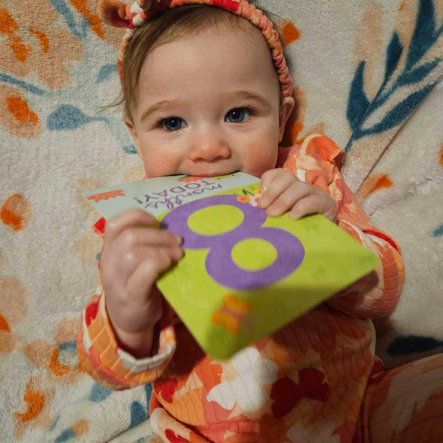 Ellora joined the competition — help win amazing prizes! baby, biting, blanket, businesscard, clothing, face, happy, head, paper, person, photography, portrait, quilt, sleeve, smile, symbol, text