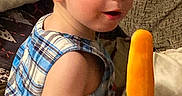 Coby joined the competition — help win amazing prizes! toddler, child, popsicle, blue_plaid, sitting, couch, indoor, snack, summer_treat, curious, small_child, face, arm, legs, hair, light_skin, clothing, food, relaxing, home