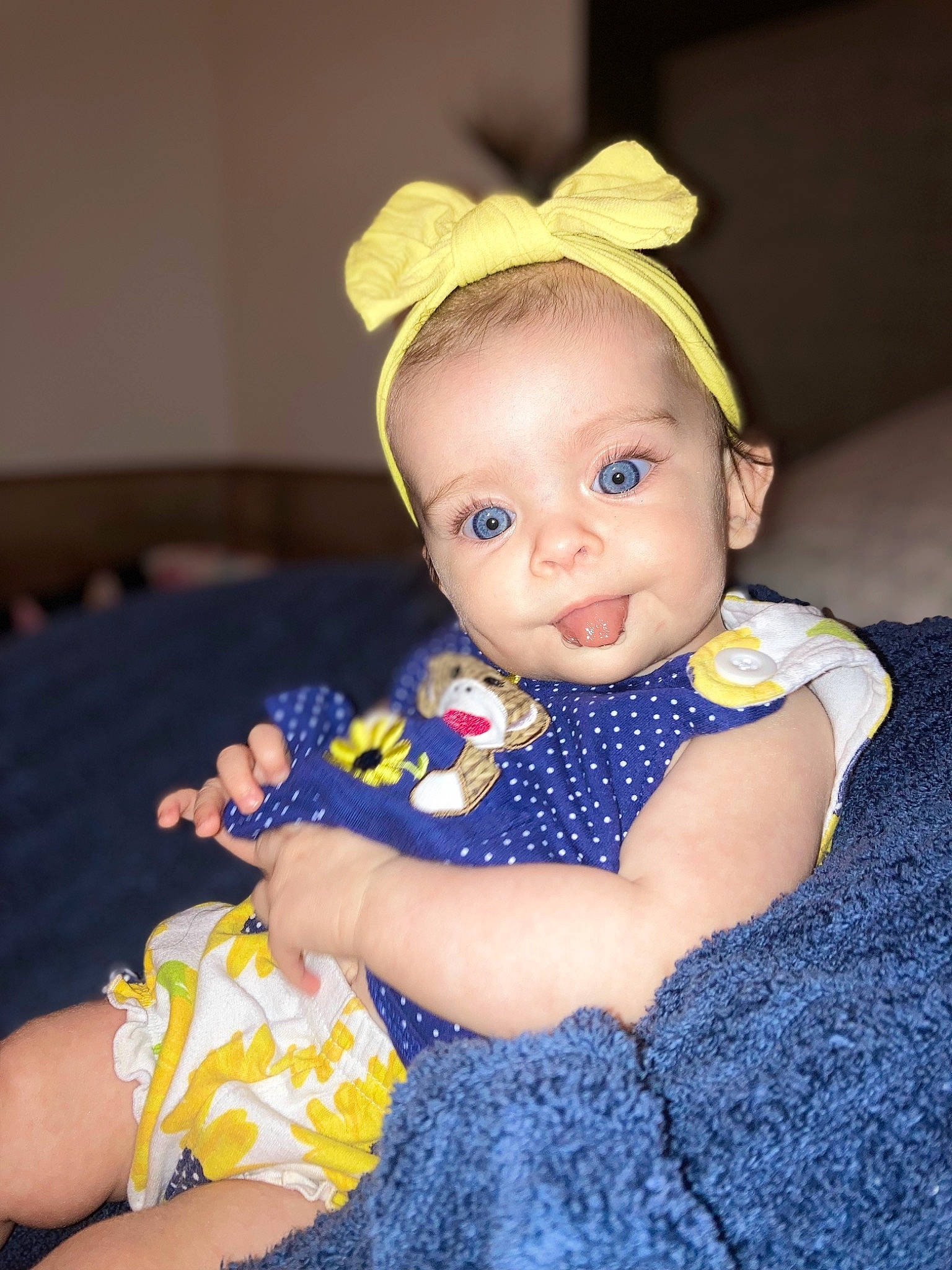 Beverly is registered to the contest to win money with this photo: baby, baby_toddler_clothing, cheek, child, costume_hat, day_dress, doll, electric_blue, fashion_accessory, headgear, iris, one_piece_garment, pattern, person, portrait_photography, sitting, skin, sleeve, toddler, toy