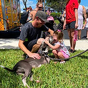 Hope joined the competition — help win amazing prizes! casual_clothing, child, dog, family, girl, grass, ice_cream_truck, leash, man, outdoor, people, pet, sidewalk, smiling, stroller, sunglasses, sunny, tree, water_bottle, woman