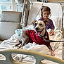 Hope is registered to the contest to win money with this photo: blanket, care, child, comfort, dog, furniture, girl, healthcare, hospital_bed, hospital_room, indoors, leash, medical_equipment, patient, purple_clothing, rest, smiling_dog, sweater, therapy_dog, white_bed
