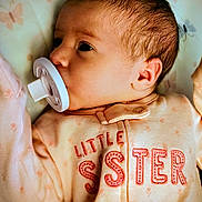 Harlie is registered to the contest to win money with this photo: baby, pacifier, infant, onesie, clothing, sleeping, child, face, skin, newborn, cute, young, portrait, lying_down, soft_lighting, indoor, peaceful, closeup, small, adorable