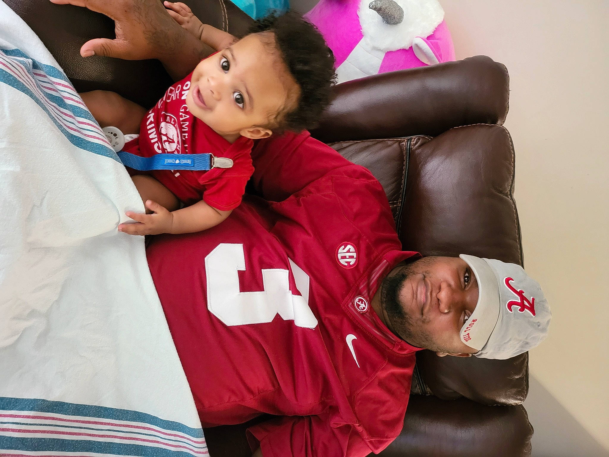 Jerome joined the competition — help win amazing prizes! baby, baby_toddler_clothing, carmine, child, comfort, couch, event, facial_expression, fun, gesture, happy, headwear, magenta, person, red, sitting, skin, sleeve, sportswear, t_shirt