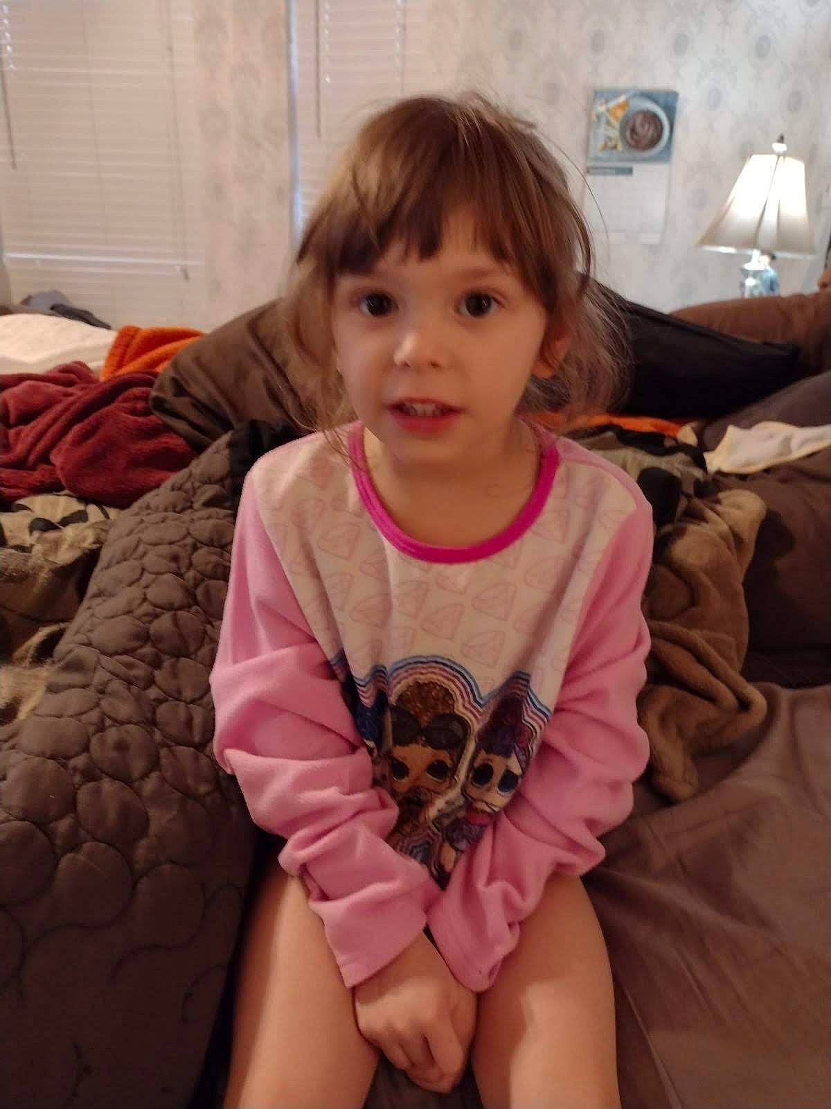 Sadie is registered to the contest to win money with this photo: baby_toddler_clothing, cheek, comfort, eye, face, facial_expression, floor, flooring, fun, hair, hairstyle, happy, human_body, iris, mouth, person, pink, skin, sleeve, textile