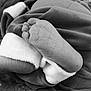 Woodson joined the competition — help win amazing prizes! baby, feet, infant, black_and_white, close_up, soft_fabric, wrinkles, skin, sleeping, cozy, blanket, foot, newborn, texture, monochrome, bed, cuddle, rest, young_child, comfort
