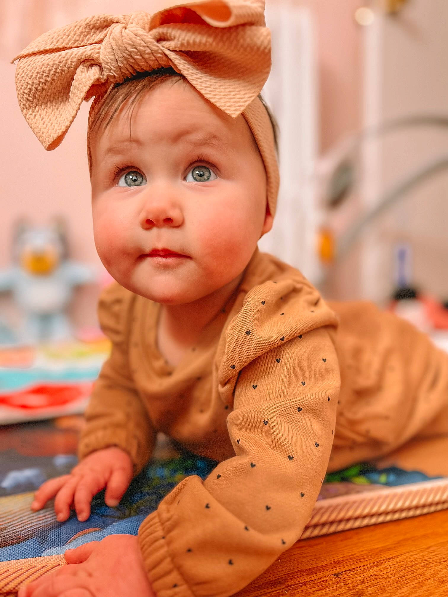 Oakley Rae is registered to the contest to win money with this photo: baby, baby_toddler_clothing, cap, cheek, child, chin, costume_hat, crawling, floor, flooring, fun, happy, headwear, nose, orange, peach, person, sitting, skin, sleeve