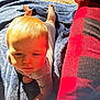 baby, child, tummy, blanket, blue_blanket, sunlight, outdoor, red_checkered, fabric, hand, face, head, skin, clothing, infant, expression, young_child, person, daylight, resting
