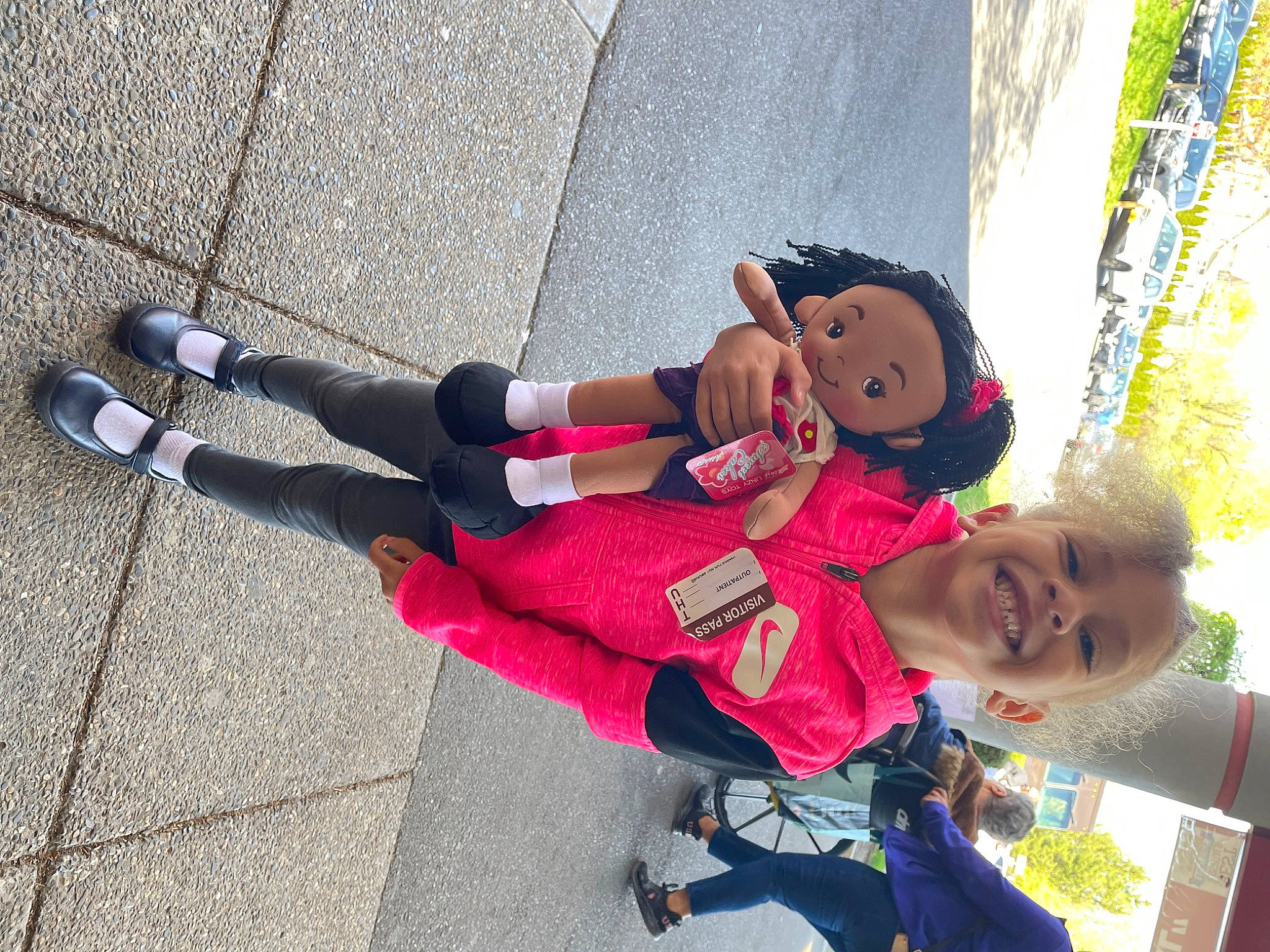 Caroline is registered to the contest to win money with this photo: asphalt, carmine, child, foot, fun, glove, happy, human_leg, joy, knee, leisure, person, recreation, road, road_surface, sandal, sidewalk, thigh, tourism, toy