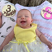 Sophie is registered to the contest to win money with this photo: accessories, baby, babylaughing, clothing, cushion, dress, face, furniture, happy, head, homedecor, jewelry, laughing, necklace, newborn, person, photography, portrait, sitting, t_shirt