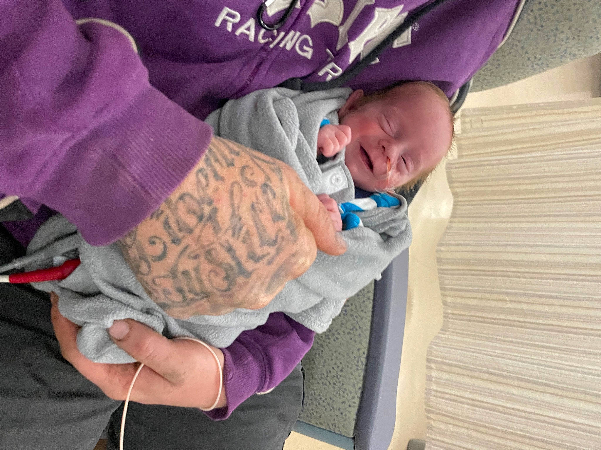Cassius is registered to the contest to win money with this photo: baby, baby_products, baby_toddler_clothing, bracelet, child, comfort, event, fashion_accessory, fun, gesture, hand, happy, magenta, person, purple, room, sitting, sleeve, toddler, violet