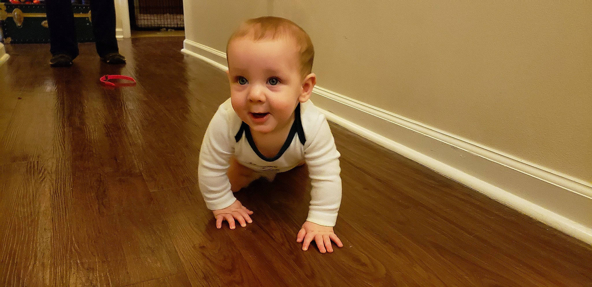 Eric is registered to the contest to win money with this photo: baby, baby_toddler_clothing, cheek, child, crawling, floor, flooring, fun, happy, hardwood, laminate_flooring, person, plank, skin, sleeve, smile, toddler, varnish, wood, wood_flooring