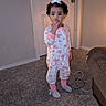 bow, cables, carpet, child, closed_door, curly_hair, furniture, heart_pattern, home, indoor, living_room, onesie, person, pink, purple_shoes, socks, standing, thoughtful, toddler, white