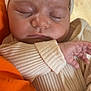 baby, child, closeup, cozy, cute, face, hand, headband, indoor, infant, newborn, orange_background, peaceful, pink_plush, portrait, resting, ribbed_clothing, skin, sleeping, soft_texture