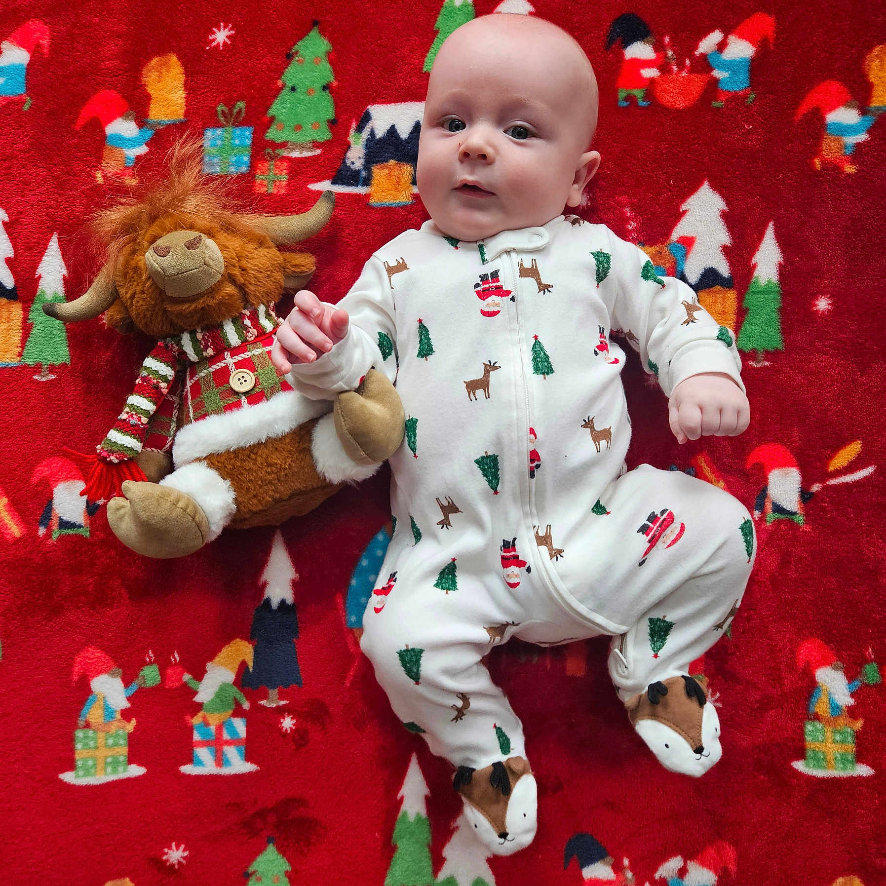 Ryker is registered to the contest to win money with this photo: applique, baby, blanket, bodypart, clothing, doll, face, finger, head, homedecor, pajamas, pattern, person, photography, plush, portrait, quilt, sitting, teddybear, toy