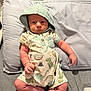 Kasen joined the competition — help win amazing prizes! baby, infant, hood, onesie, dinosaur_pattern, pillow, blanket, lying_down, clothing, cute, child, newborn, indoors, expression, soft_fabric, legs, arms, skin, person, sleepwear