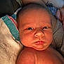 Kasen is registered to the contest to win money with this photo: baby, infant, closeup, skin, face, expression, towel, arm, tattoo, newborn, person, human, child, indoors, resting, chubby_cheeks, portrait, serious, holding, colorful_towel
