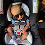 baby, sunglasses, car_seat, chicco, infant, child, blue_clothing, white_socks, safety_harness, indoor, person, seat, cute, newborn, baby_boy, car_seat_strap, small_finger, head, legs, footwear