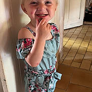 Lea participe au concours pour gagner de l'argent avec cette photo : blonde_hair, child, cute, door, dress, floor, floral_pattern, happy, holding, indoor, light, person, playful, sandals, shadow, smiling, standing, tiled_floor, wall, young_child