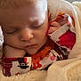 baby, sleeping, blanket, infant, cozy, face, hand, soft, clothing, pattern, colorful, cute, peaceful, indoor, closeup, newborn, resting, comfort, wrapped, portrait
