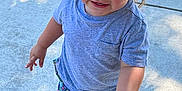 James joined the competition — help win amazing prizes! toddler, child, boy, outdoor, sidewalk, casual_clothing, gray_tshirt, colorful_shorts, gray_shoes, green_stripe, walking, smiling, rosy_cheeks, sunlight, shadow, hair, playful, young, person, daytime