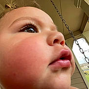 James joined the competition — help win amazing prizes! child, face, close_up, outdoor, porch, chain, curious, expression, skin, lips, nose, eye, eyelashes, ear, daylight, residential_area, bicycle, architecture, grass, window