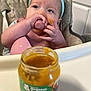 baby, high_chair, baby_food, butternut_squash, messy, face, headband, blue, kitchen, food_jar, feeding, child, infant, pink_bib, hands, smearing, container, cabinet, organic, toddler