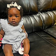 Kentoria is registered to the contest to win money with this photo: baby, black, bow, child, couch, cute, dress, expression, foot, girl, hair, hand, indoors, leather, nails, pink, portrait, sitting, skin, striped