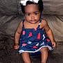 Kentoria joined the competition — help win amazing prizes! baby, barefoot, bow, brown_couch, child, comfortable, couch, curly_hair, cute, dress, face, girl, indoor, infant, navy_blue, patterned_clothing, portrait, sitting, smile, young_child