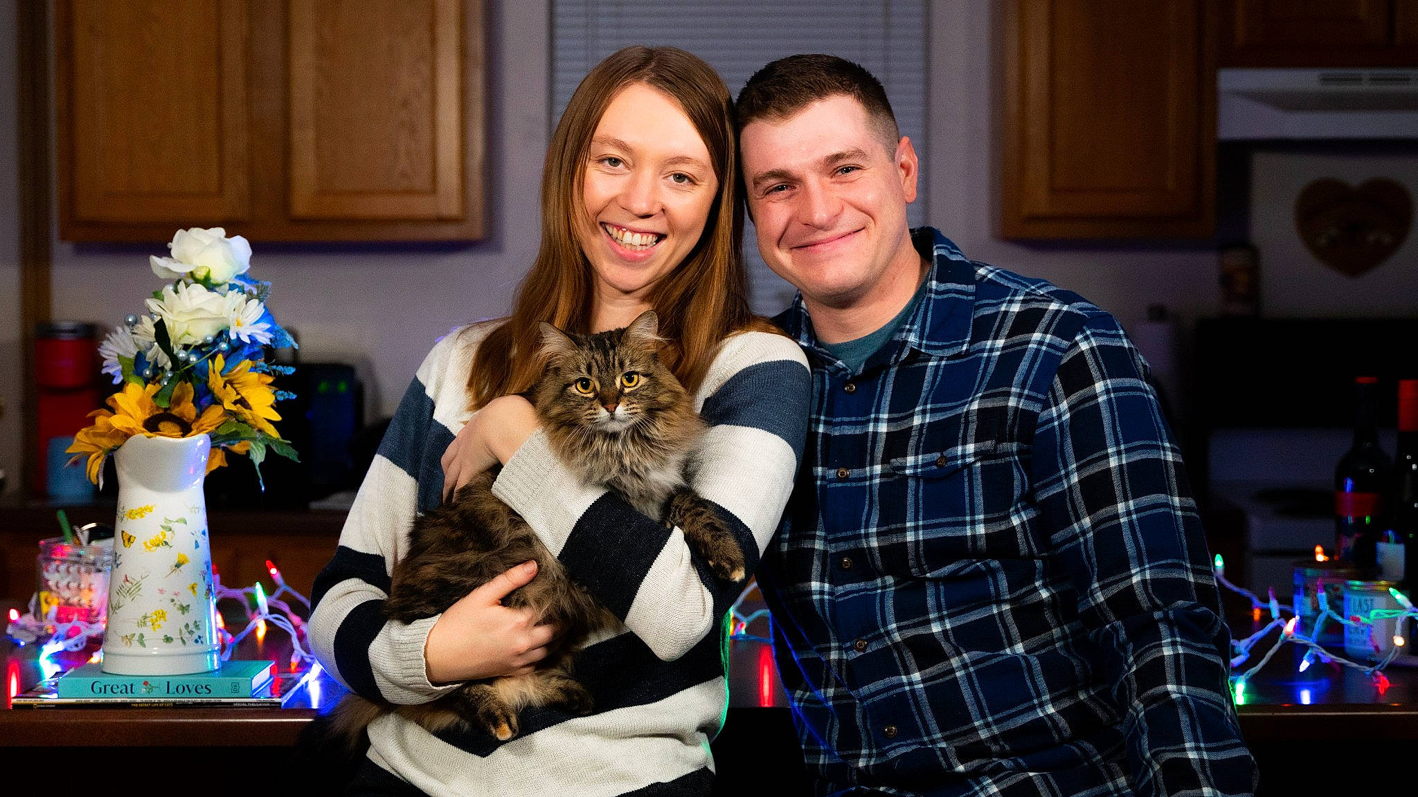 Mary Jane is registered to the contest to win money with this photo: beard, cat, companion_dog, event, facial_expression, fawn, felidae, fun, fur, happy, lap, party, pattern, plaid, room, sitting, smile, t_shirt, tartan, youth