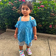Mariam joined the competition — help win amazing prizes! child, toddler, girl, portrait, outdoor, garden, flowers, hydrangea, plants, blue_dress, lace_clothing, rainbow_shoes, sneakers, sidewalk, residential, houses, standing, serious_expression, hair_bows, daylight