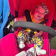 Ada-Jane is registered to the contest to win money with this photo: baby, stroller, child, smile, headband, clothing, sock, pacifier, seatbelt, fabric, pattern, pink, yellow, black, white, outdoor, sunlight, cute, infant, comfort
