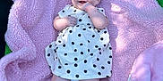 Ada-Jane is registered to the contest to win money with this photo: baby, infant, smile, dress, polka_dots, headband, blanket, pink, green, trampoline, outdoor, sunlight, happy, cute, child, person, legs, feet, hand, portrait