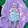 Ada-Jane joined the competition — help win amazing prizes! baby, infant, smile, dress, polka_dots, headband, blanket, pink, green, trampoline, outdoor, sunlight, happy, cute, child, person, legs, feet, hand, portrait