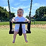 Ada-Jane is registered to the contest to win money with this photo: baby, child, swing, playground, outdoor, sunny, blue_sky, grass, trees, headband, happy, smiling, summer, daytime, infant, park, fence, barefoot, clothing, person