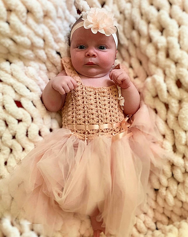 Charlotte joined the competition — help win amazing prizes! baby, baby_toddler_clothing, doll, dress, embellishment, eyelash, fashion_design, headgear, headpiece, headwear, jewellery, pattern, peach, person, pink, ruffle, sleeve, textile, toy, white