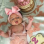 Kaylee is registered to the contest to win money with this photo: baby, pink_bow, headband, cake, butterfly, blanket, infant, two_months, cute, tongue_out, soft_texture, decorations, celebration, clothing, lying_down, portrait, child, infant_girl, baby_girl, birthday