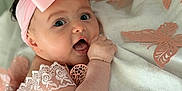 Kaylee joined the competition — help win amazing prizes! baby, infant, pink_bow, headband, lace, clothing, blanket, butterfly, soft_texture, cute, portrait, closeup, child, resting, curious, indoors, decorative, happy, skin, face