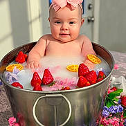 Haven joined the competition — help win amazing prizes! baby, infant, child, headband, bow, milk_bath, tub, metal_bucket, strawberries, orange_slices, flowers, floral, portrait, closeup, smile, rosy_cheeks, indoor, tablecloth, bubble_bath, cute