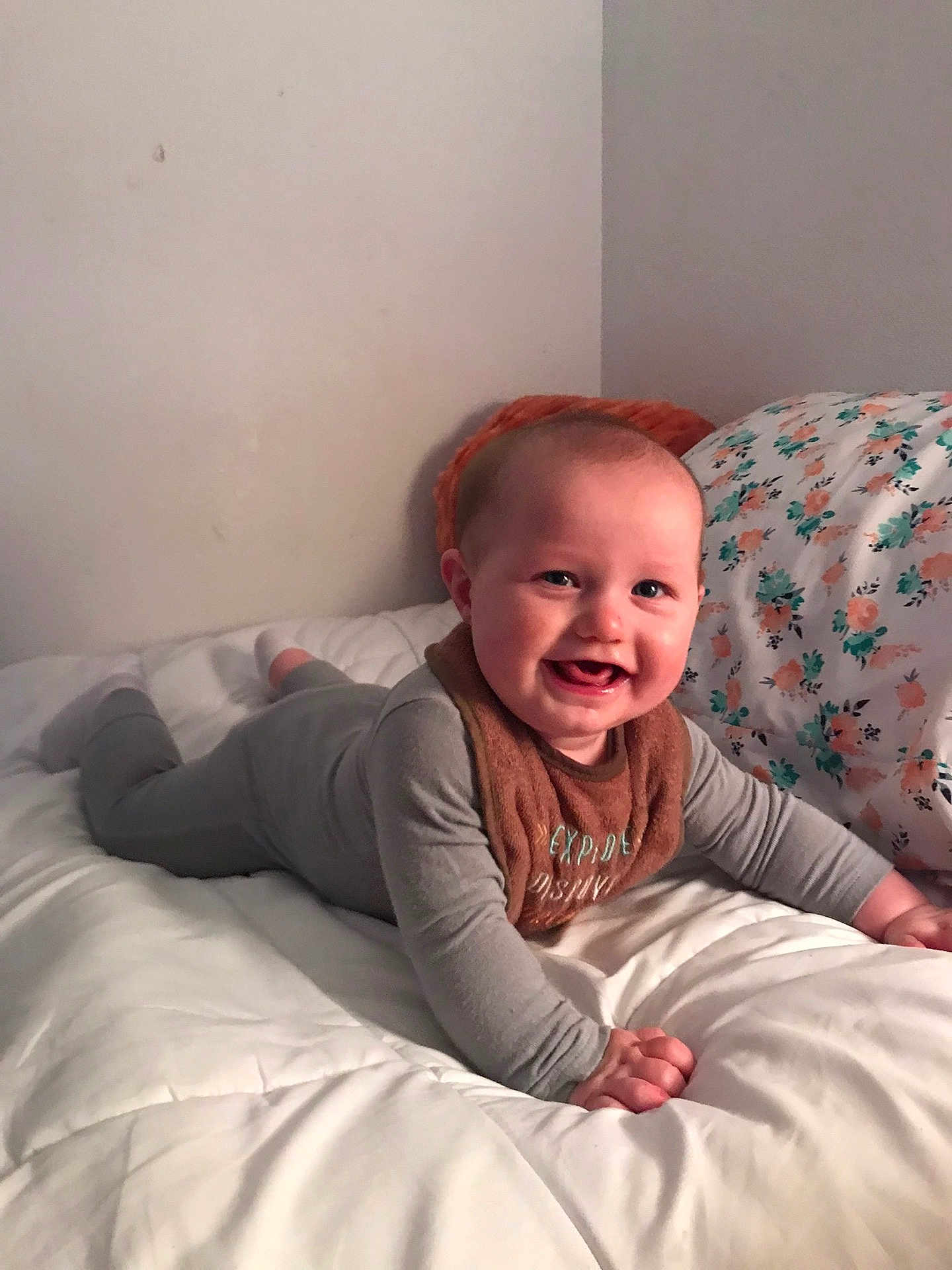 Andrew is registered to the contest to win money with this photo: baby, child, smile, pajamas, bed, blanket, pillow, indoor, happy, infant, cute, face, person, toddler, cozy, lying_down, home, comfort, soft, sleepwear