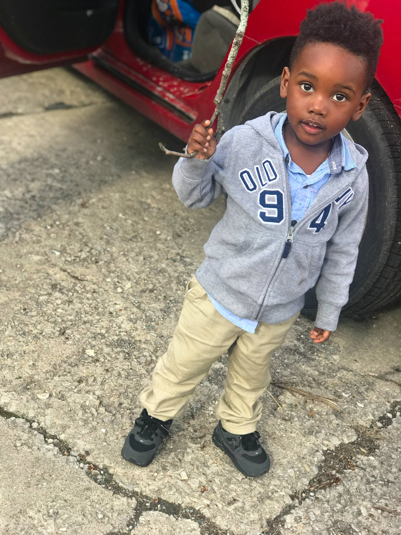 Hakeem is registered to the contest to win money with this photo: child, child_model, cool, fun, jeans, male, outerwear, people, person, photography, play, shoe, sitting, smile, toddler, vehicle