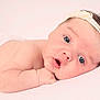 baby, infant, face, headband, flower, skin, arm, lying_down, cute, portrait, newborn, child, soft_light, expression, closeup, human, resting, peaceful, pink, white_background