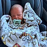 Luca is registered to the contest to win money with this photo: newborn, baby, pacifier, blanket, car_seat, sleeping, infant, cozy, child, cute, soft, comfort, patterned_blanket, wrapped, peaceful, seat, indoors, head, small, resting