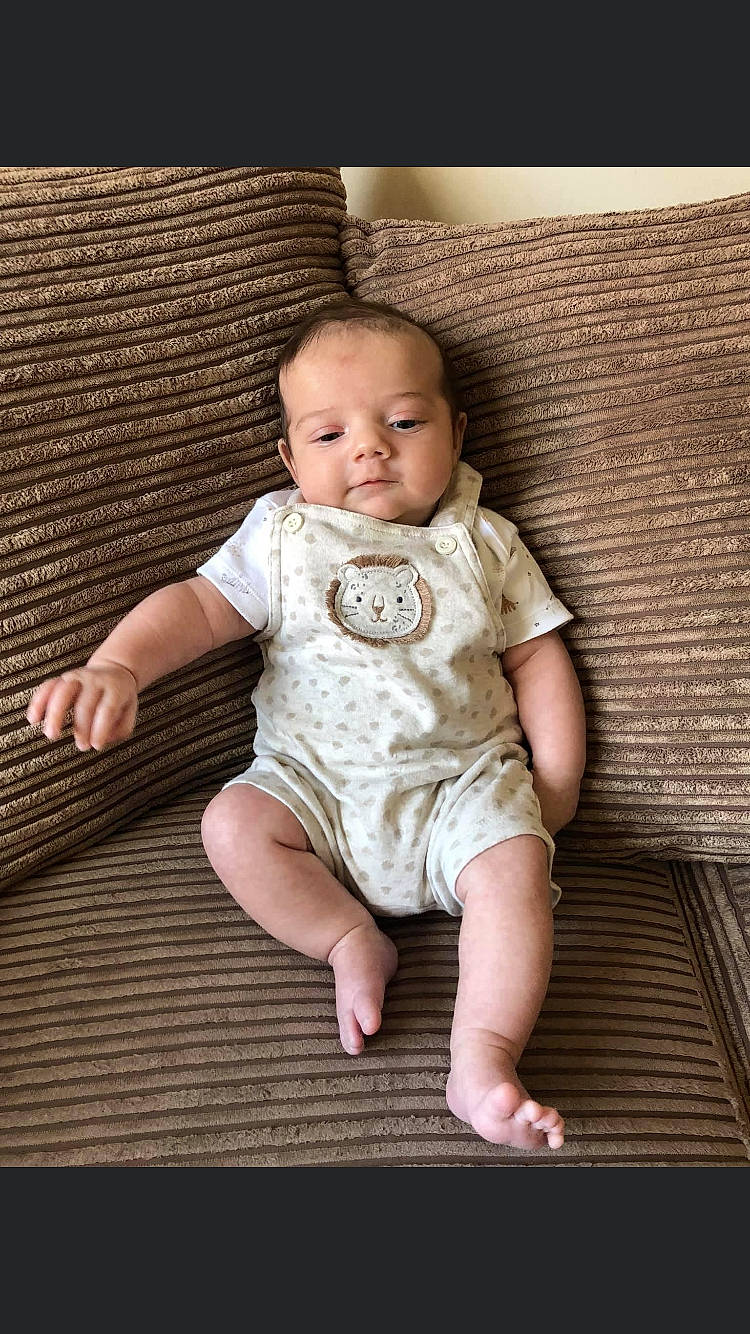 Lenny is registered to the contest to win money with this photo: baby, baby_toddler_clothing, cheek, child, child_model, comfort, eye, flash_photography, flooring, foot, happy, hardwood, pattern, person, portrait_photography, sitting, skin, sleeve, toddler, wood