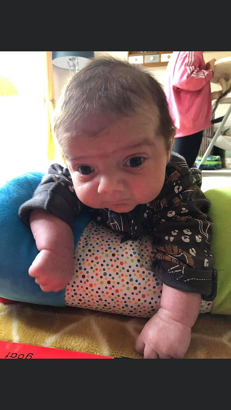 Lenny is registered to the contest to win money with this photo: baby, baby_toddler_clothing, cheek, child, cool, flooring, fun, hairstyle, happy, mouth, nose, pattern, person, plaid, play, sitting, skin, sleeve, t_shirt, toddler